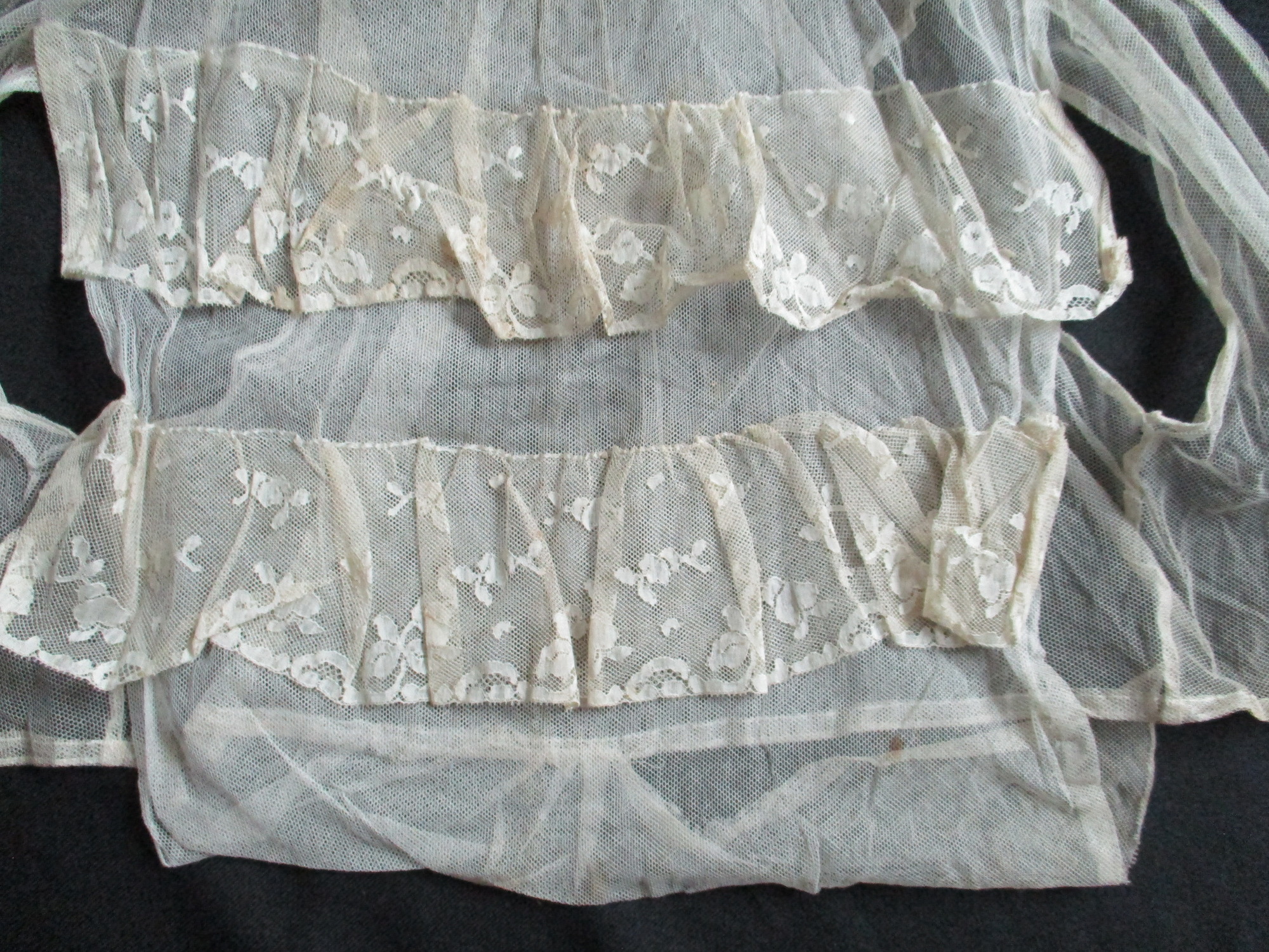 Bib and Collar: Frill detail on lace/net bib and collar.