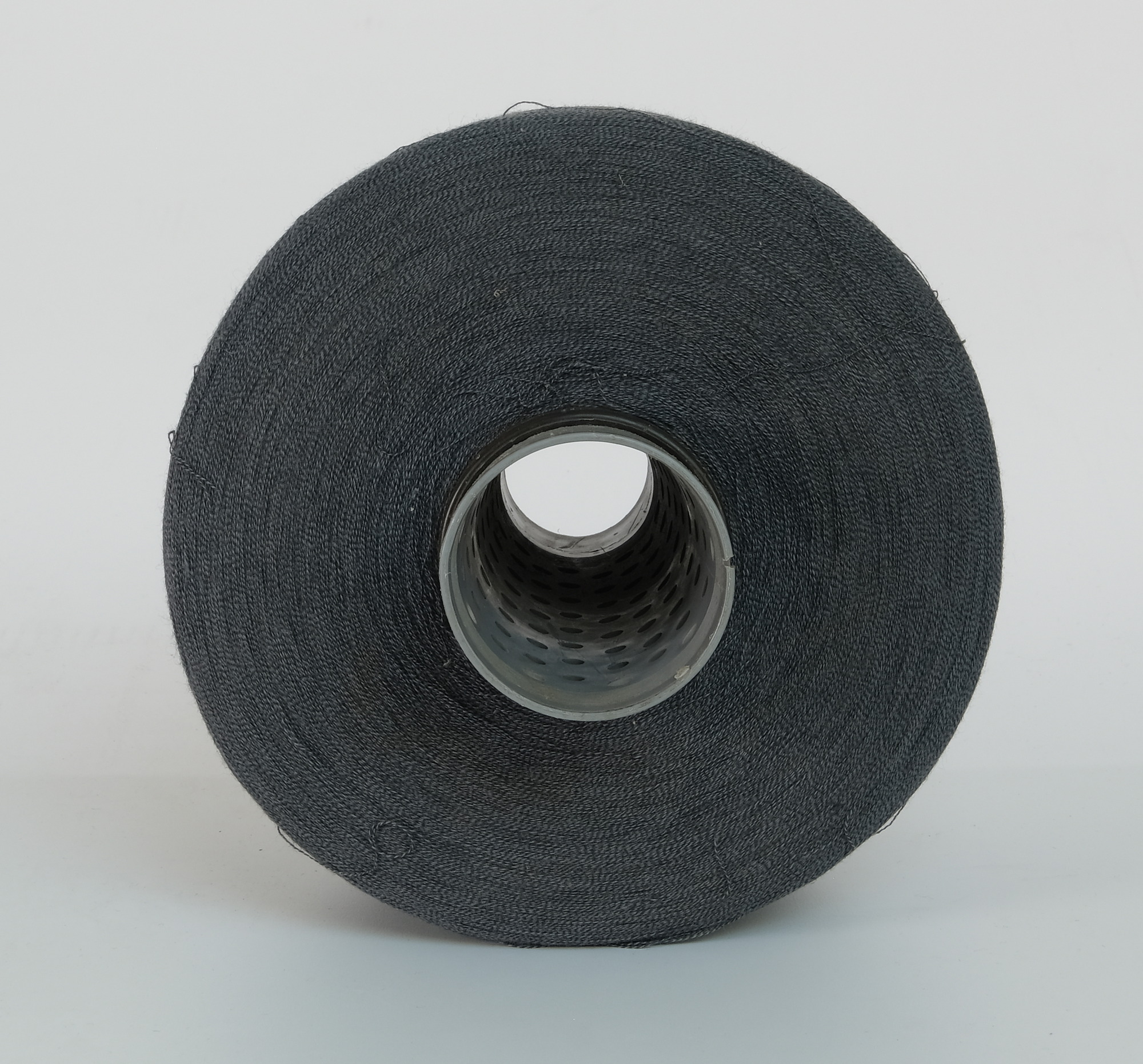 Bobbin of dark grey yarn: bottom view