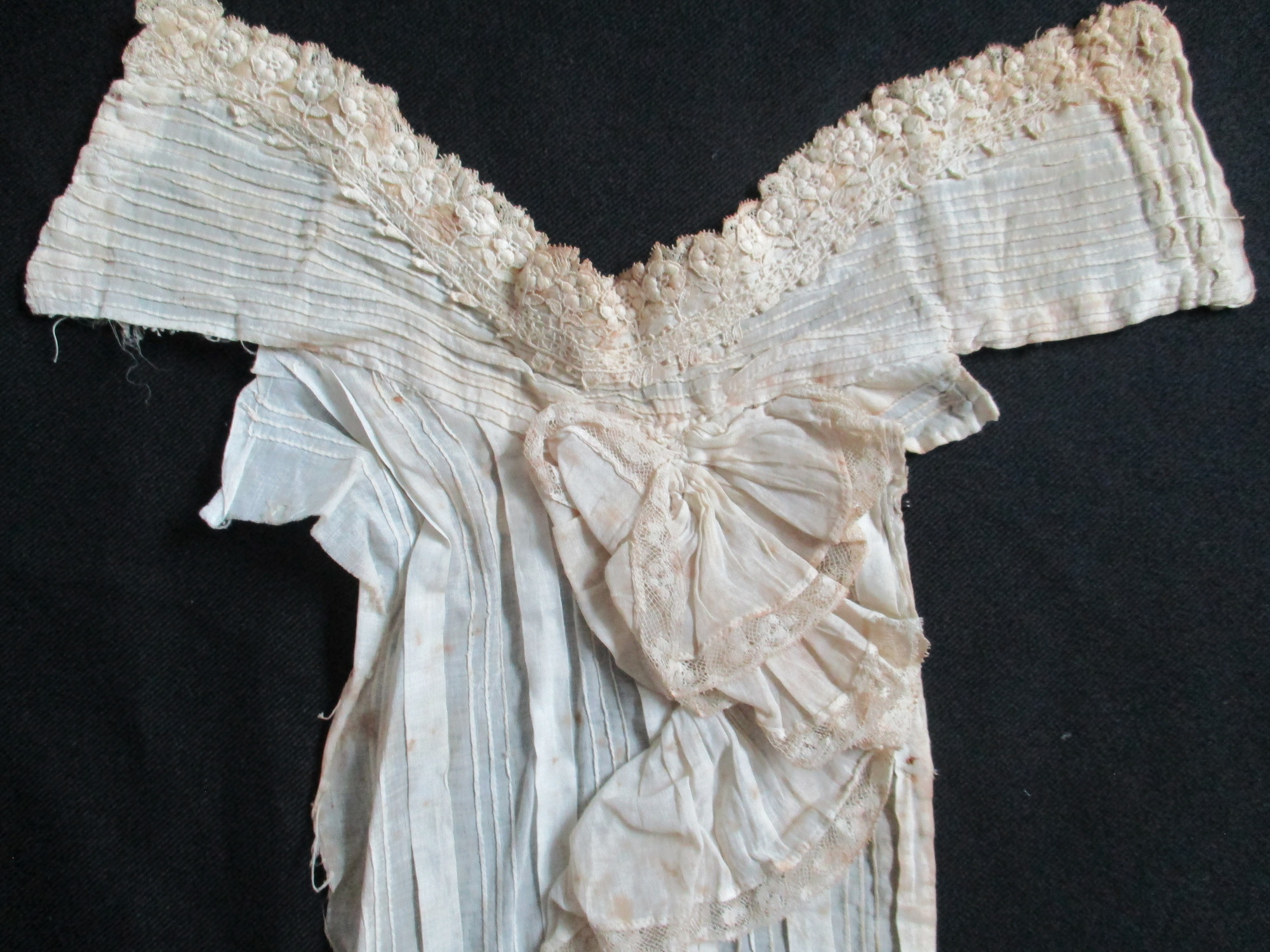 Collar and frontal: Closer image of collar and frontal highlighting lace detail around the neck and flounce down the centre.
