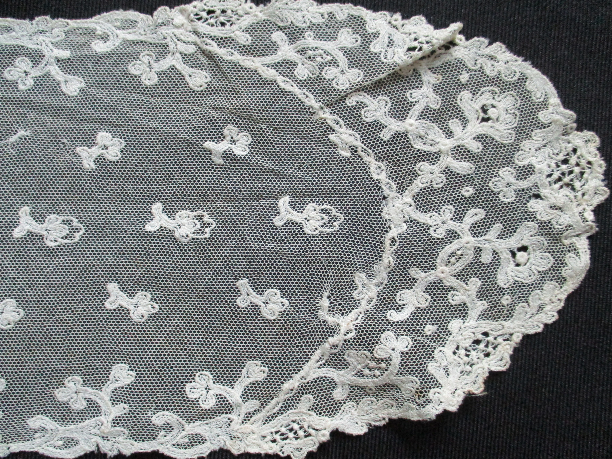Cream lace sash.: Close up image of lace sash.