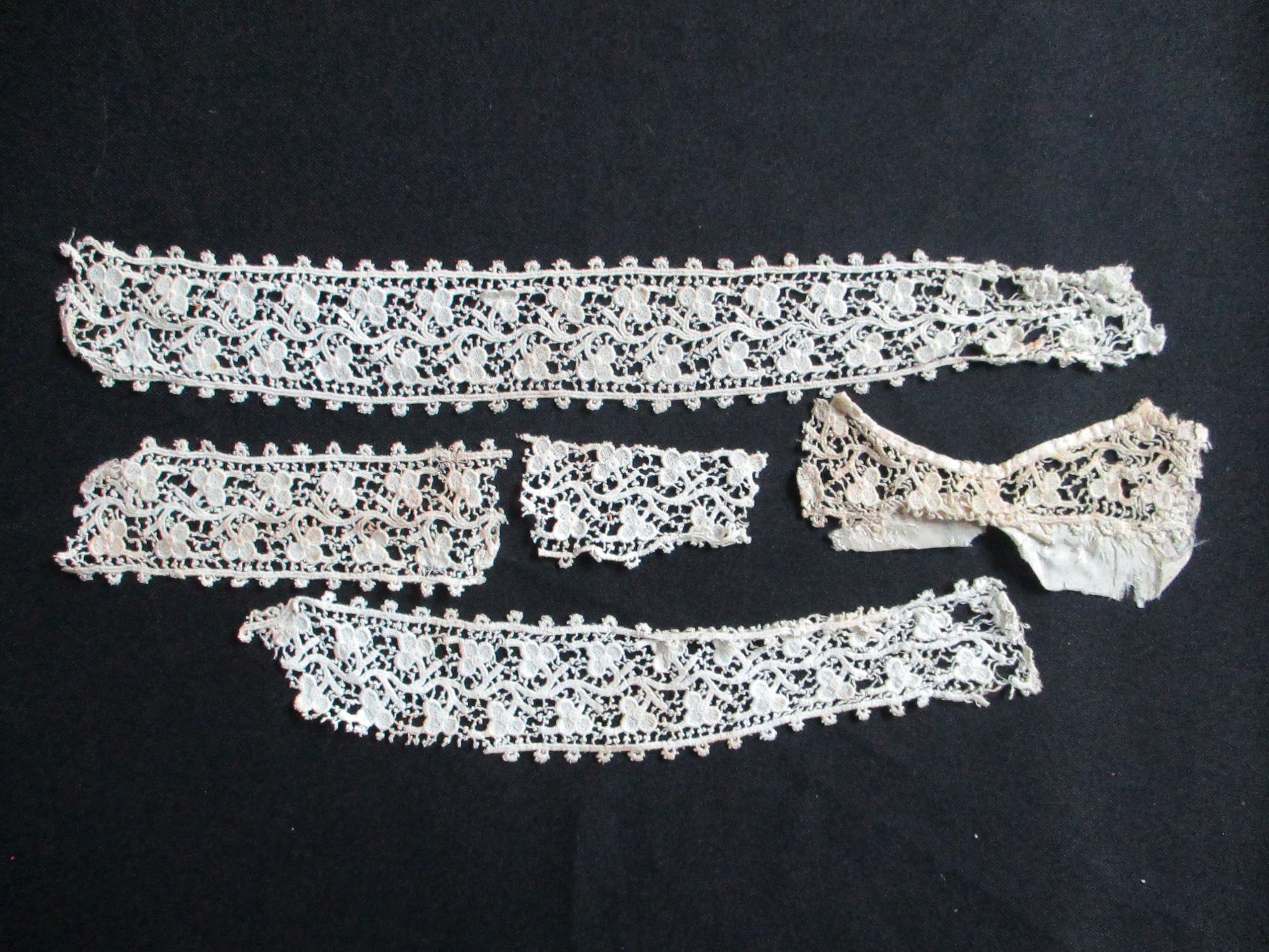 Five pieces of silk lace trim.