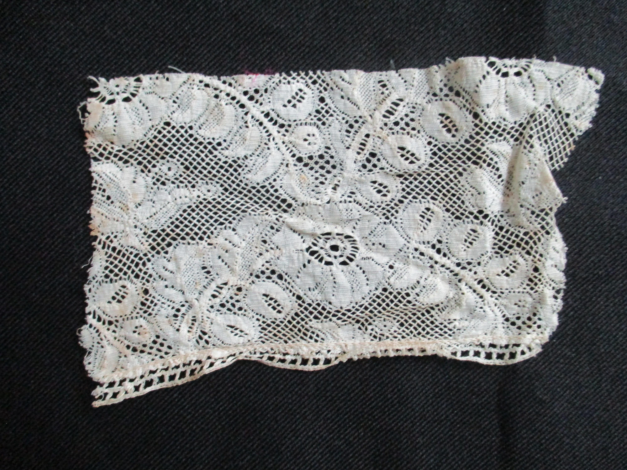 Four pieces of cream lace.: Cream silk lace offcut.