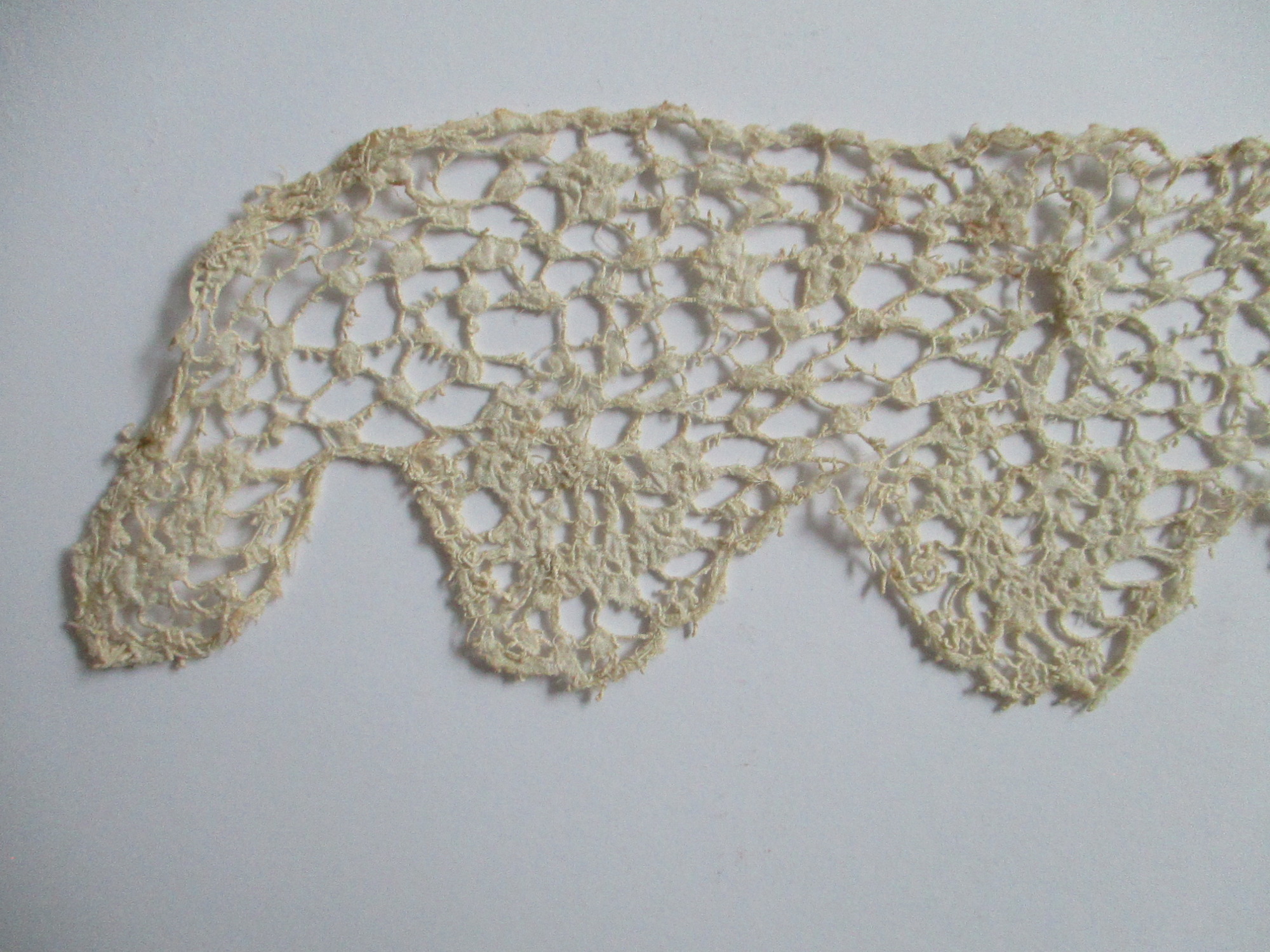 Length of cream silk lace.: End detail of cream silk lace. (i)