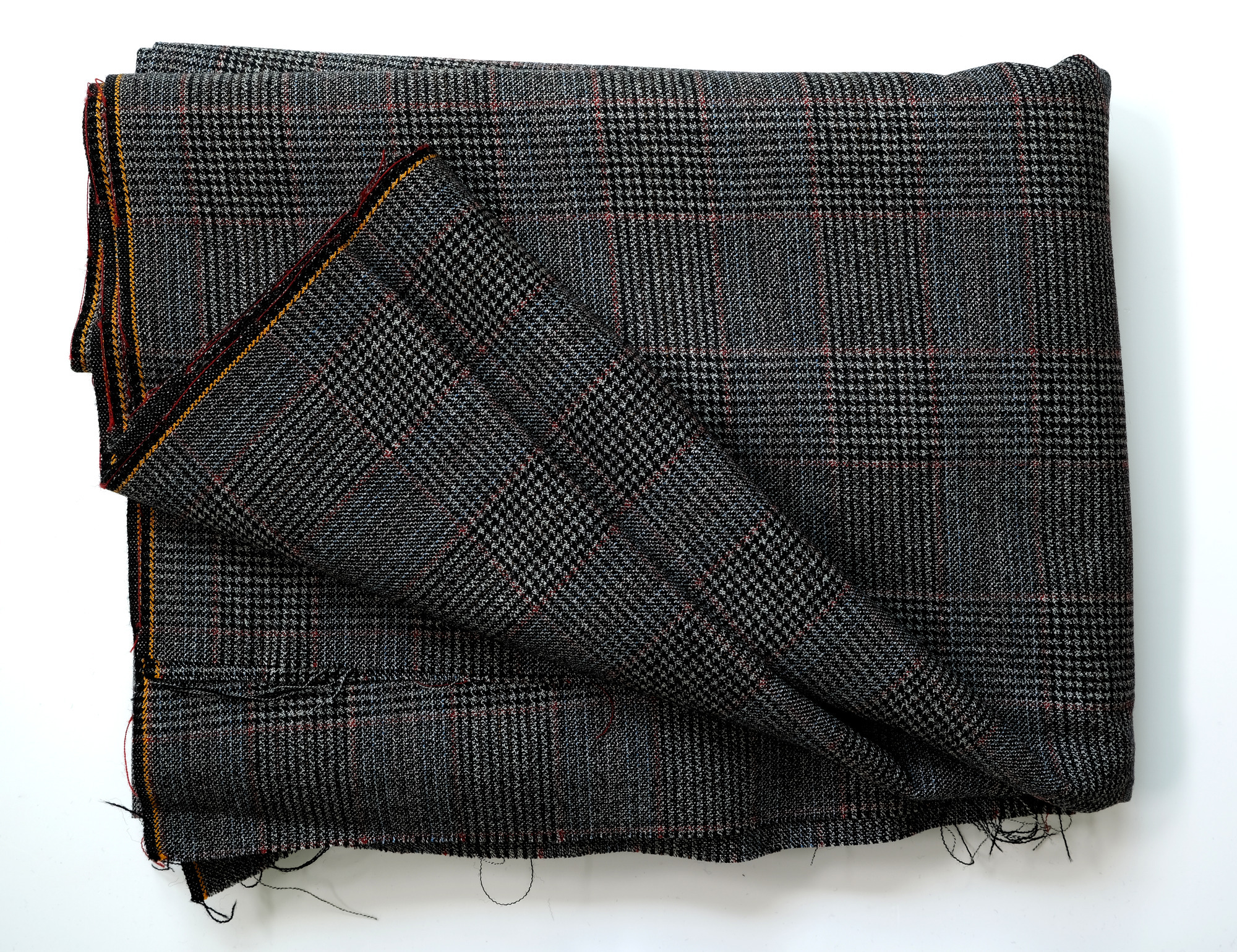 Length of dark grey, dogtooth-pattern cloth: View showing cloth folded back twice