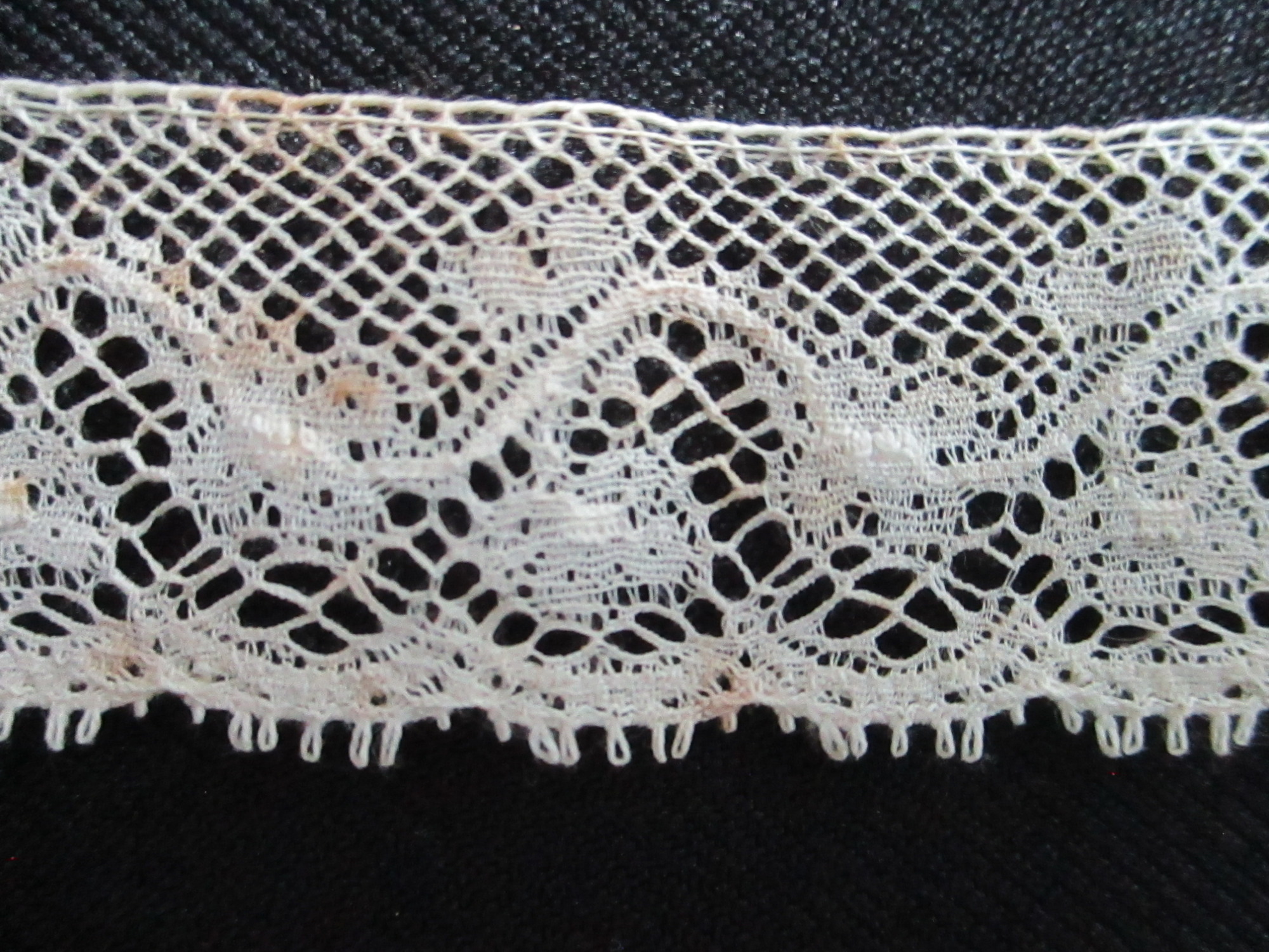 Length of lace trim.: on black background highlighting design.