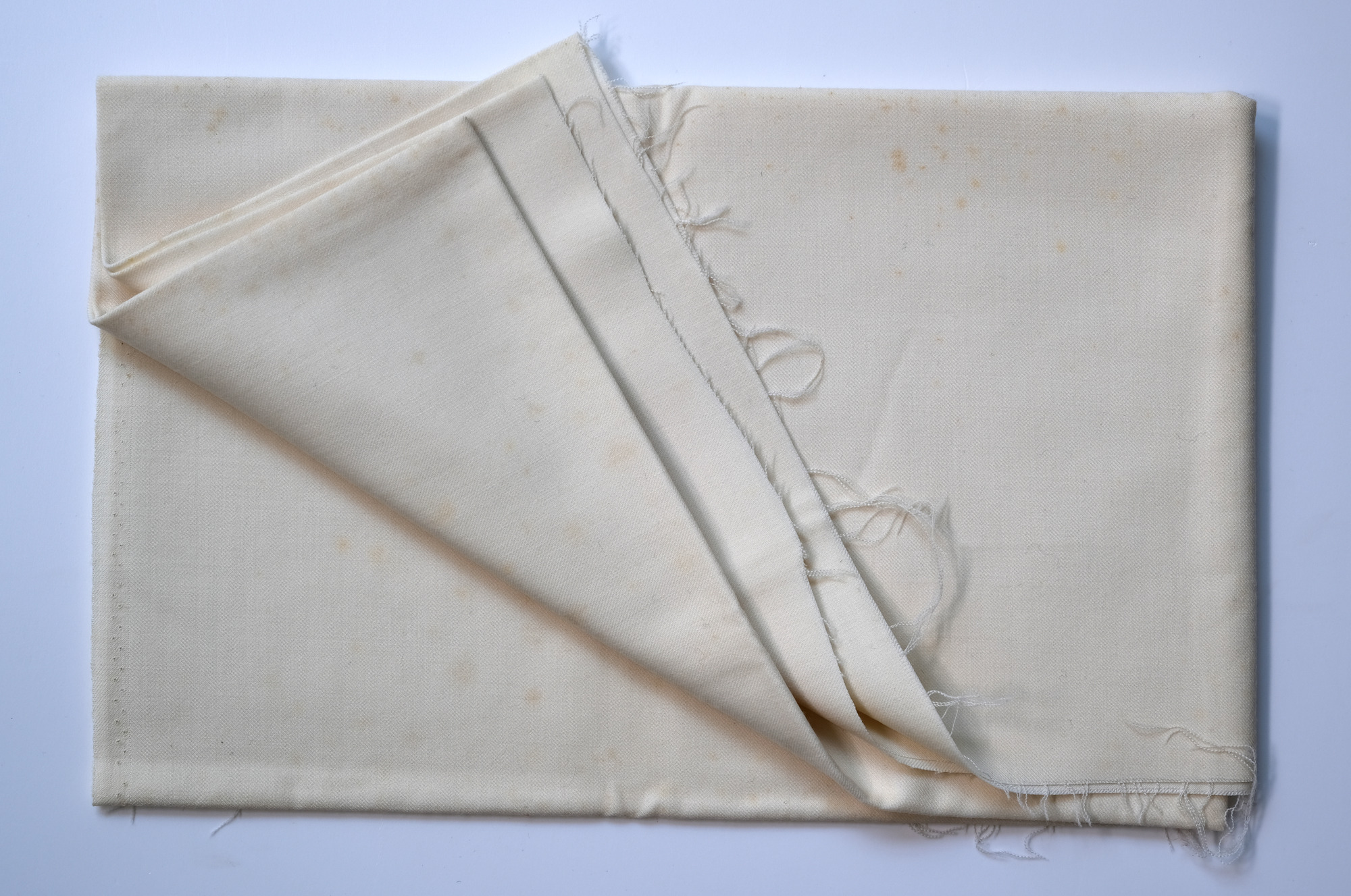 Length of white cloth: View showing cloth folded back thrice