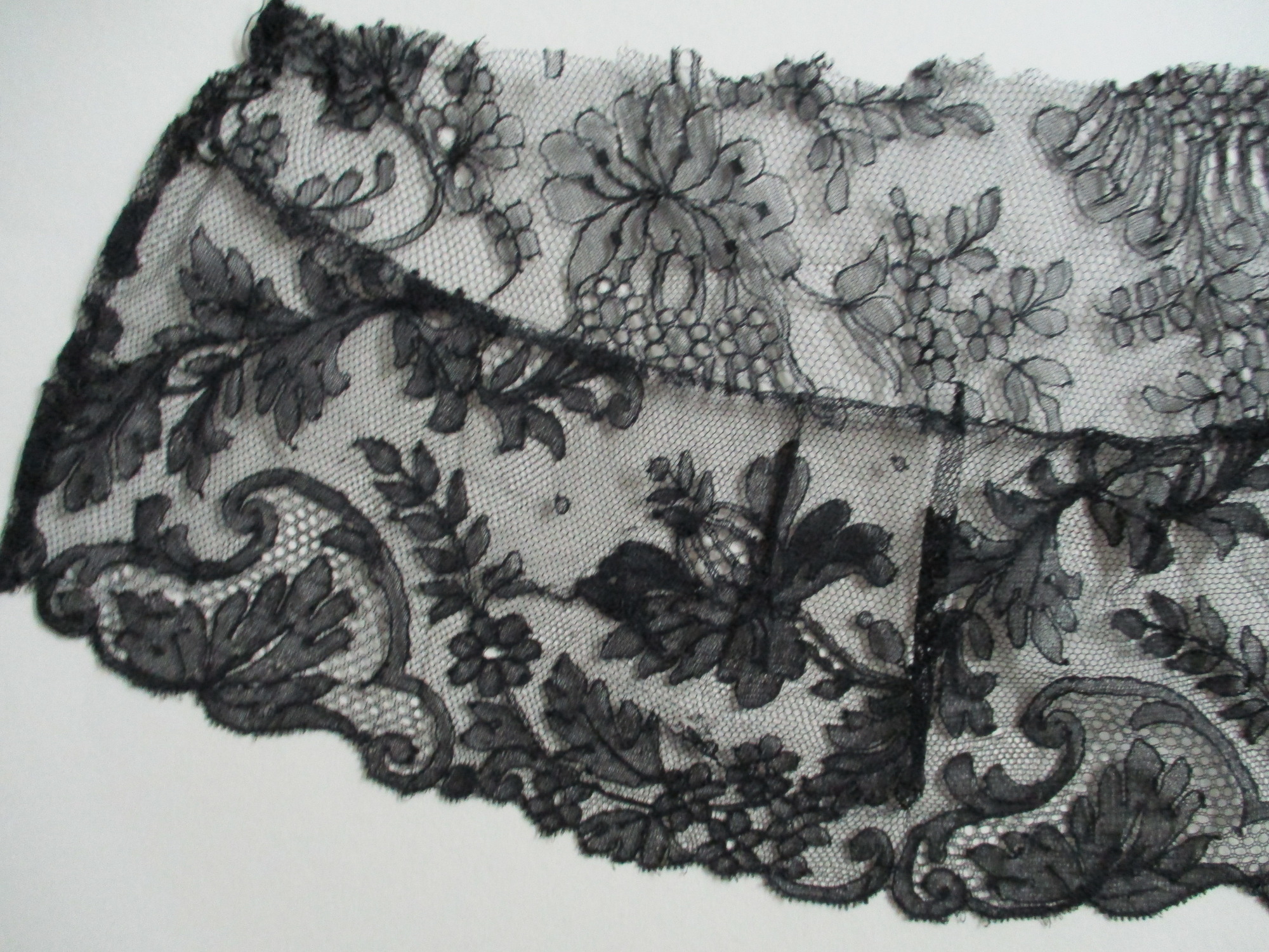 Piece of black lace netting: Black lace netting edge detail 2.