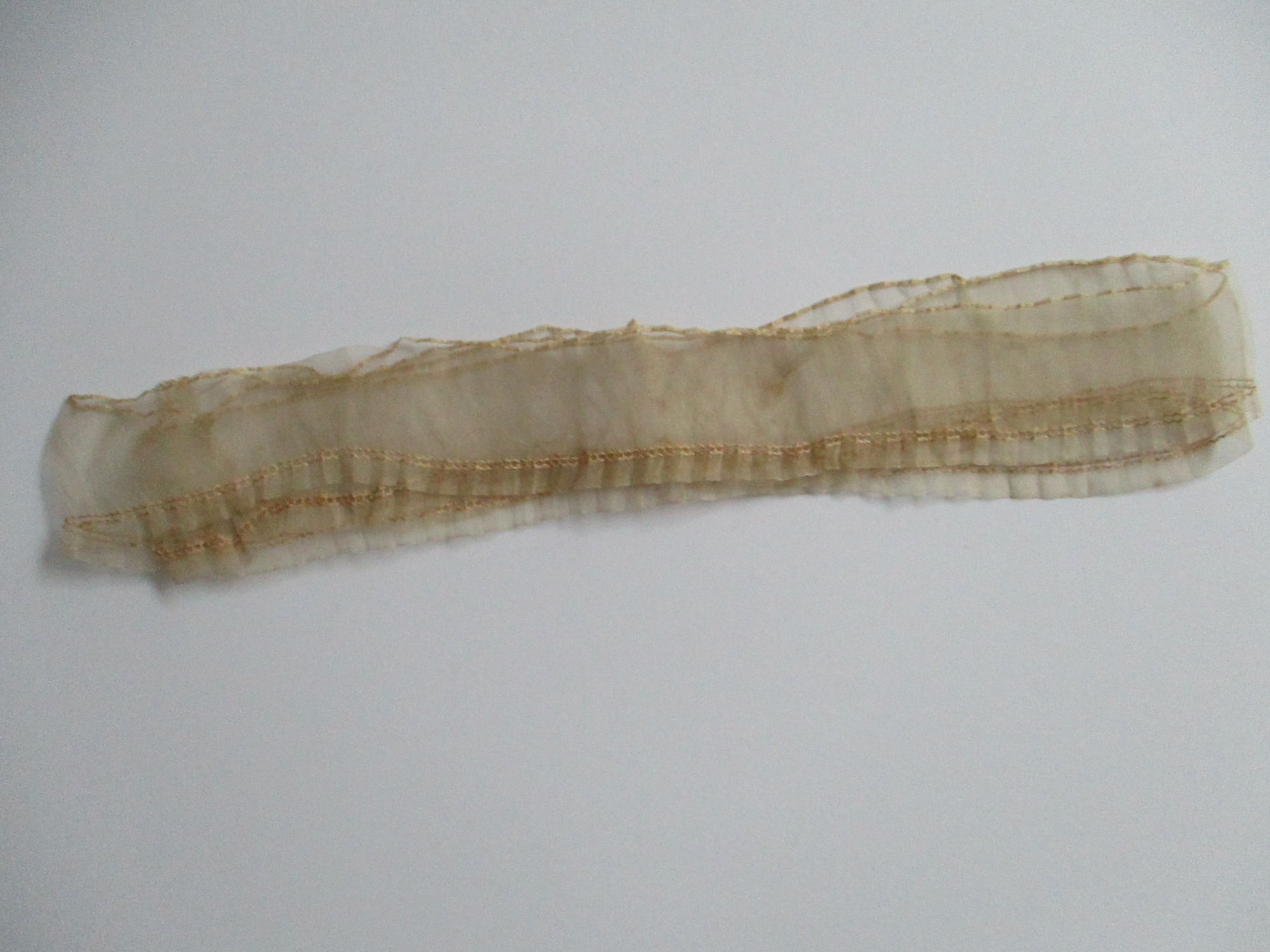 Piece of cream silk edging/trim.