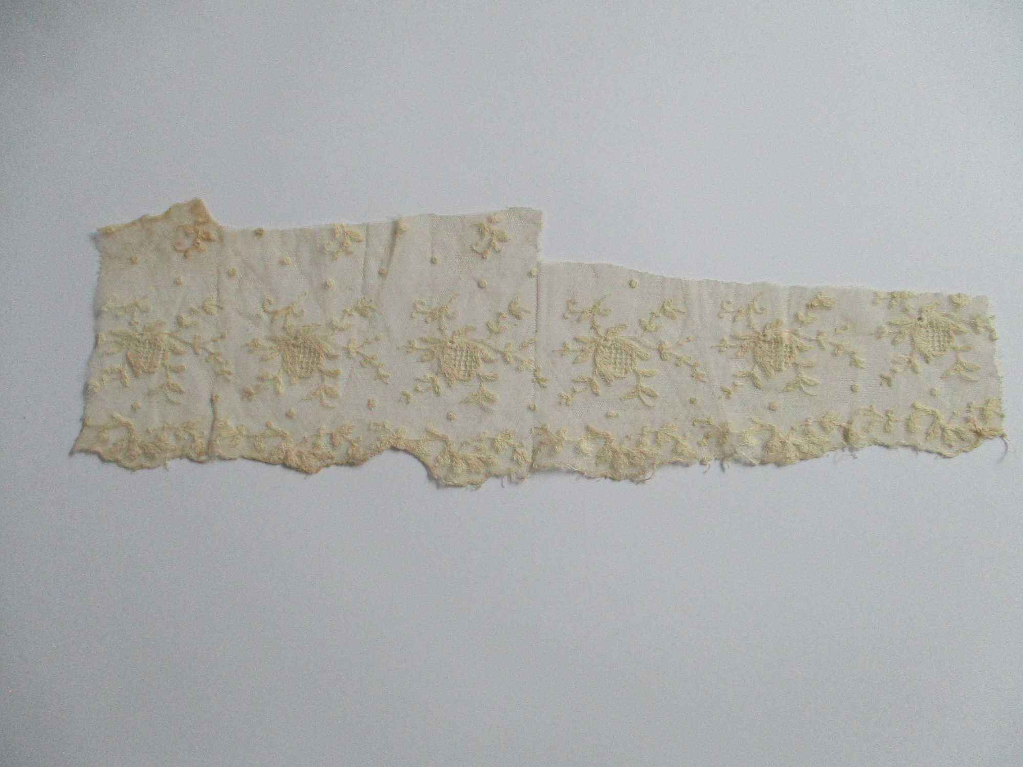 Piece of cream silk embroidered netting.: Piece of fine embroidered lace netting. (ii)