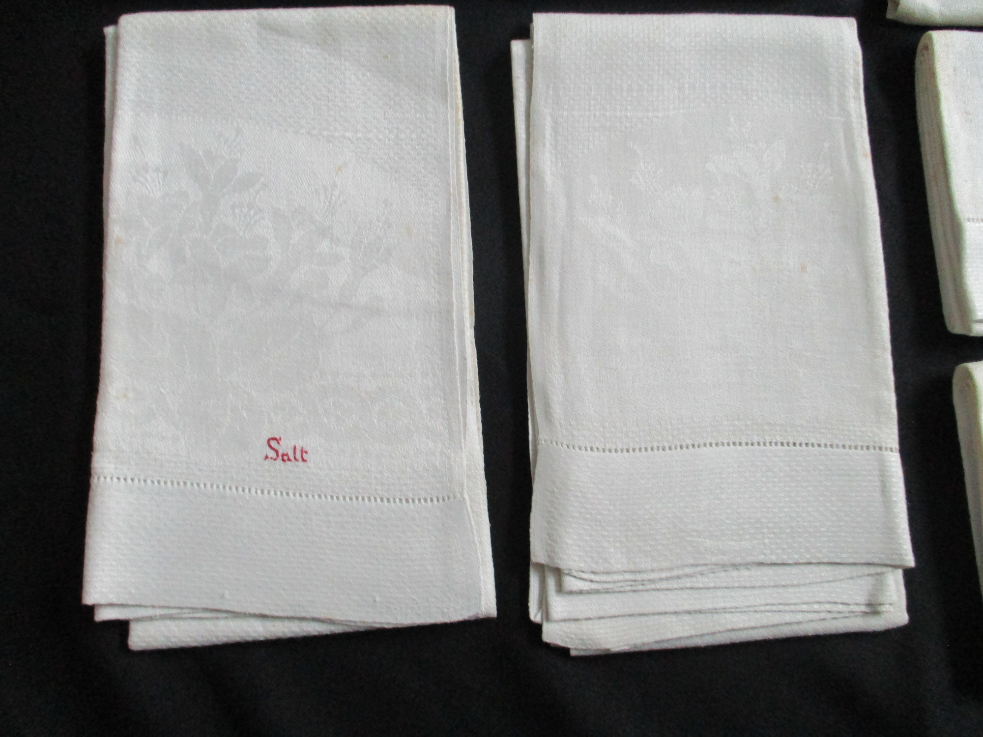 Seven cream damask towels.: Two towels, front view, one showing Salt monogram