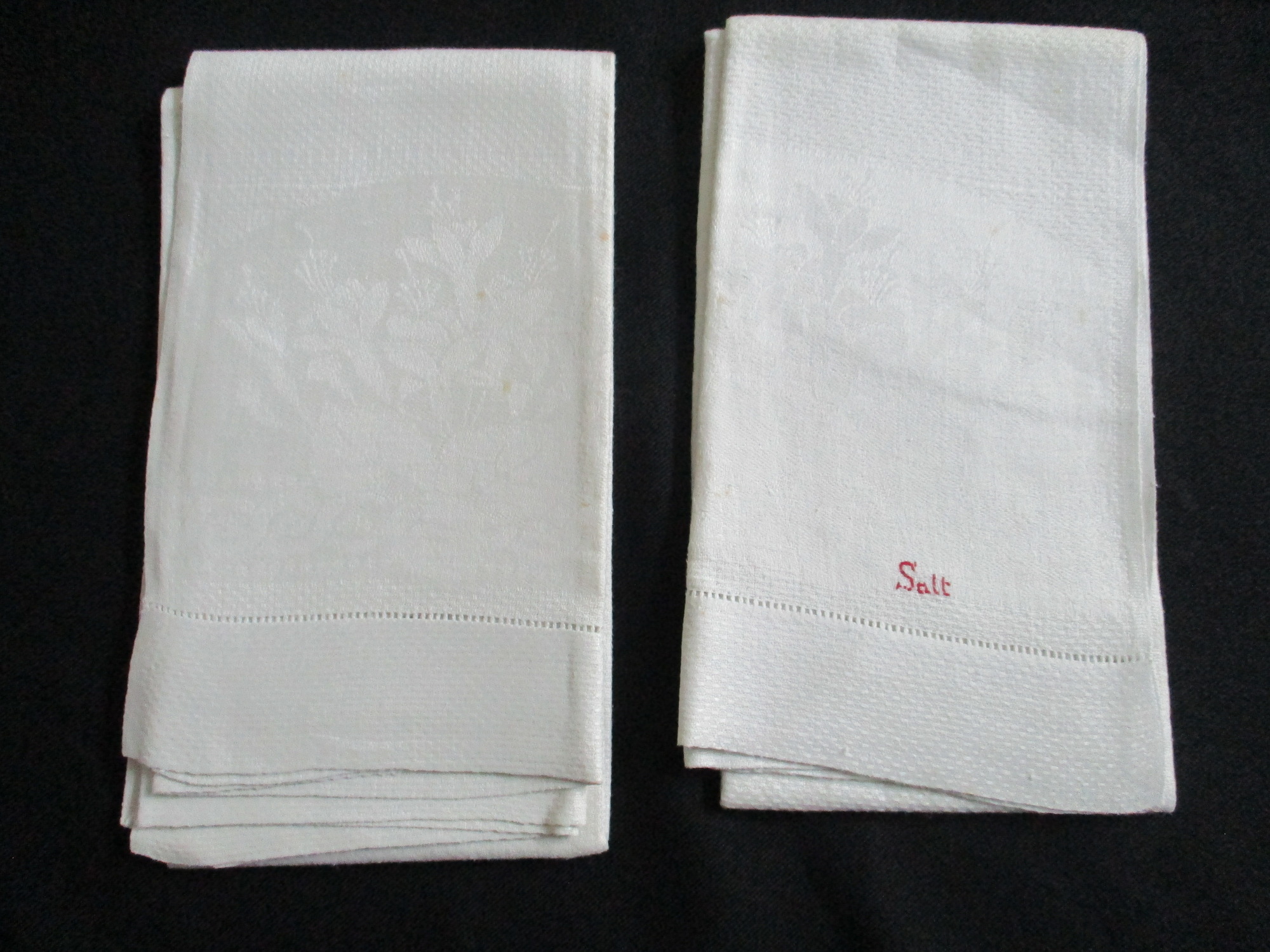 Seven cream damask towels.: Two towels, front view, one showing Salt monogram