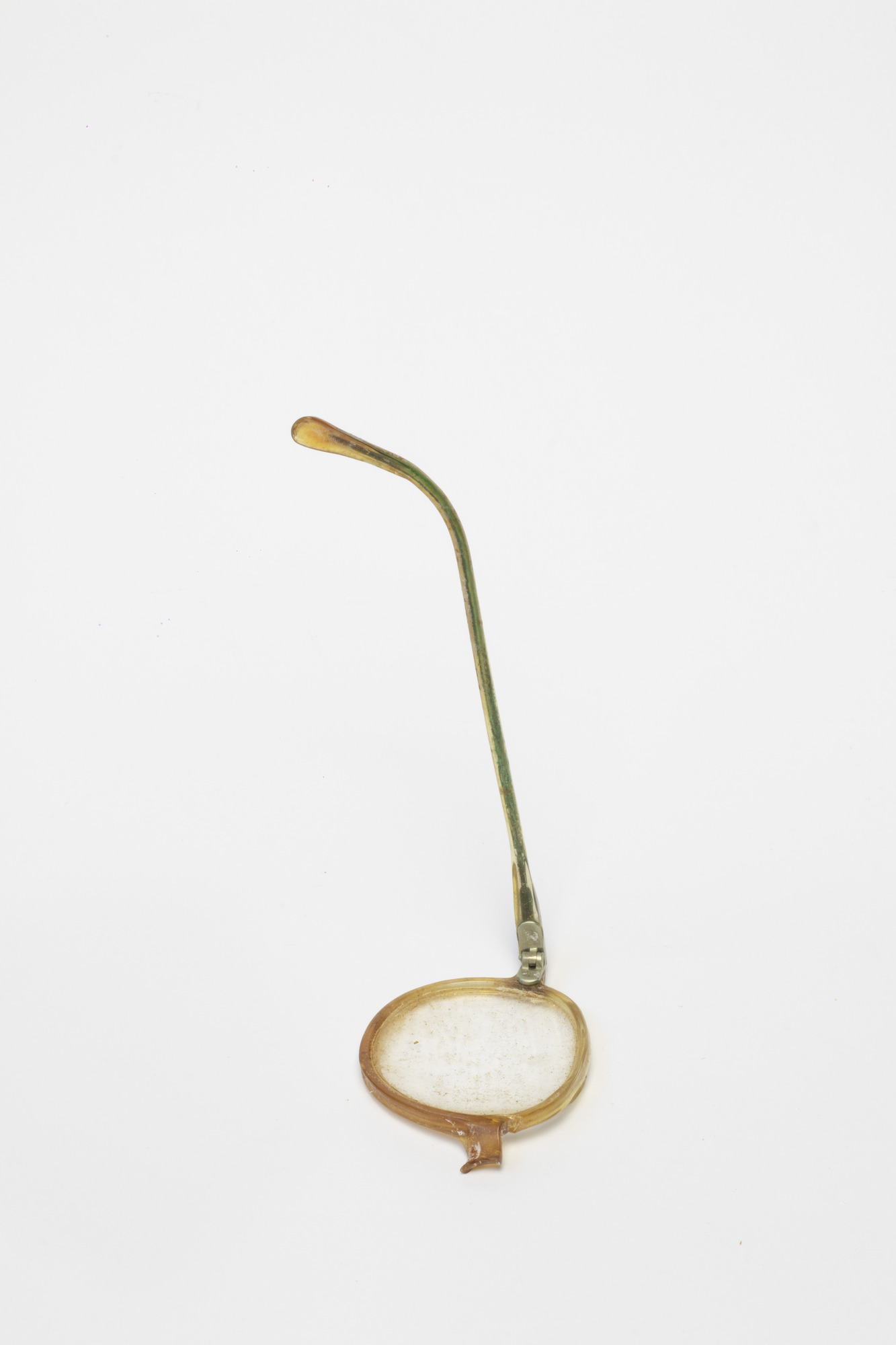 Spectacles: Left hand lens, rear view, arm raised