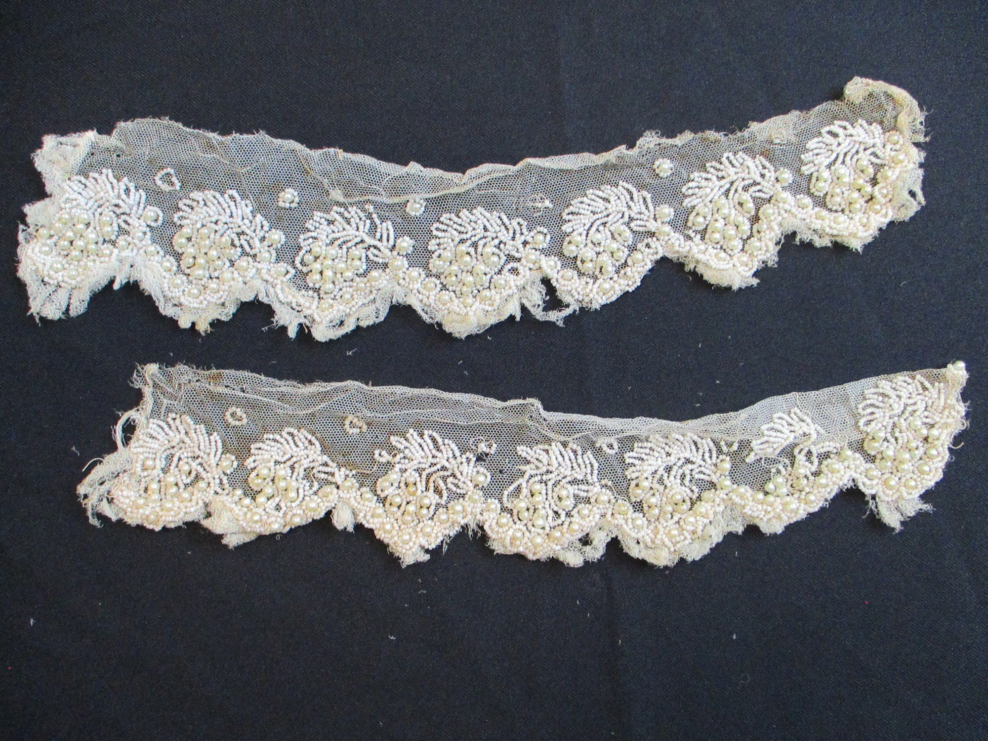 Strips of heavily beaded cream netting: Two pieces of heavily beaded cream netting. (ii)