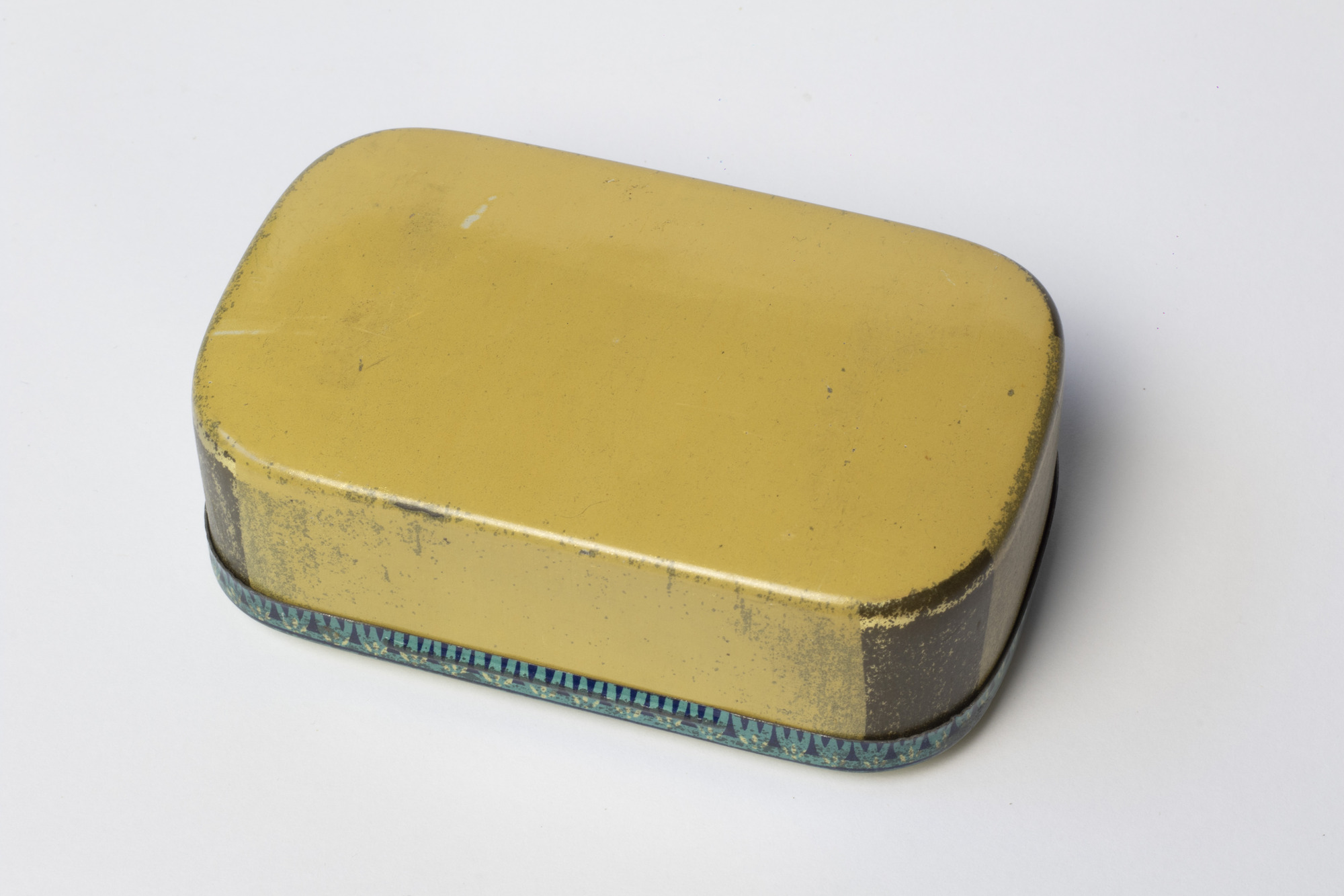 Tin box containing acorns: base view