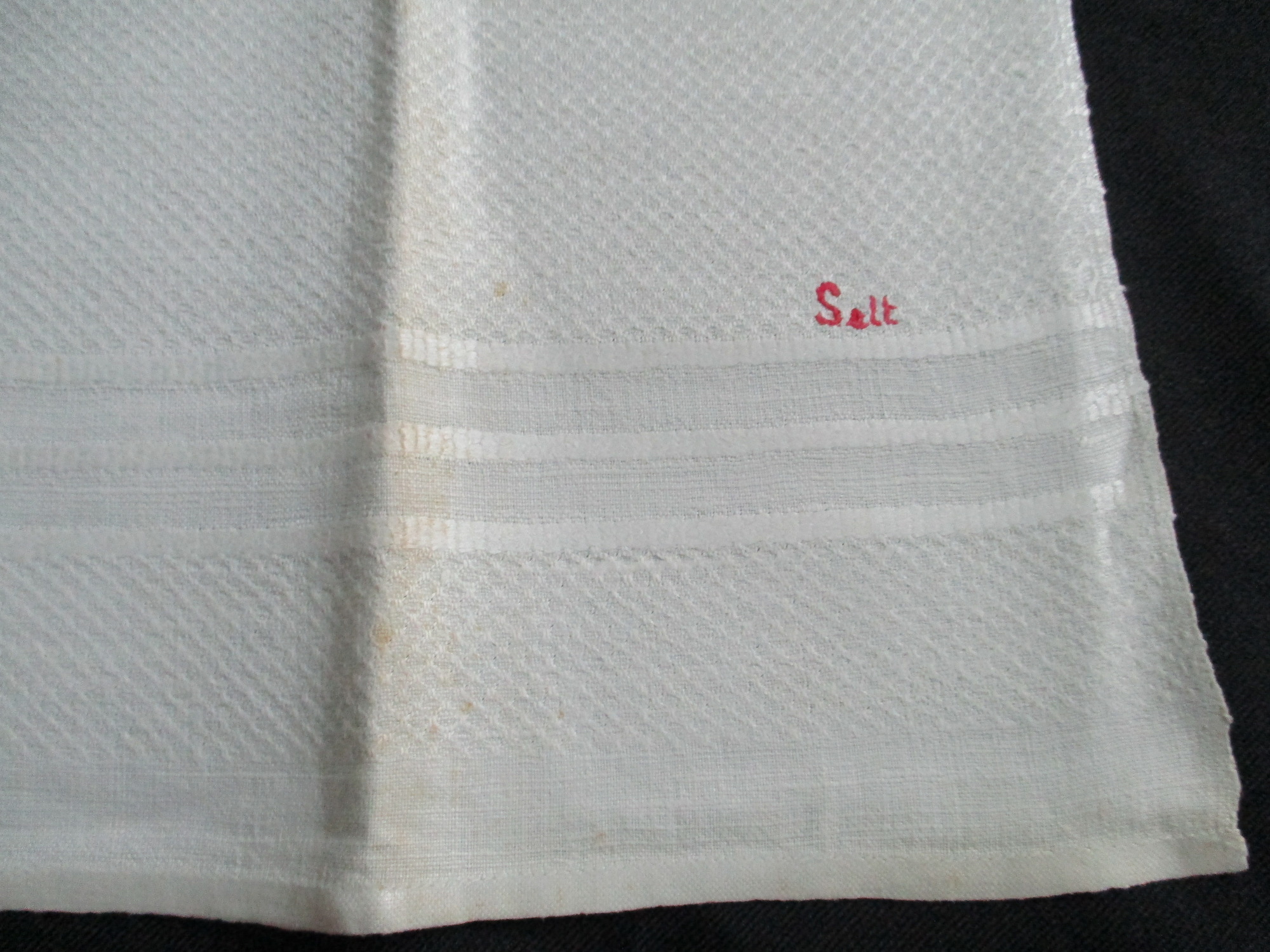 Two damask towels.: One towel fully unfolded